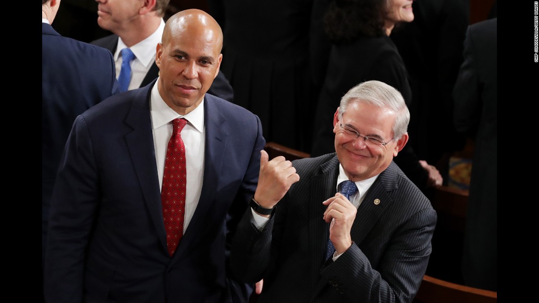 US Sens. Cory Booker and Bob Menendez arrive in the House chamber.