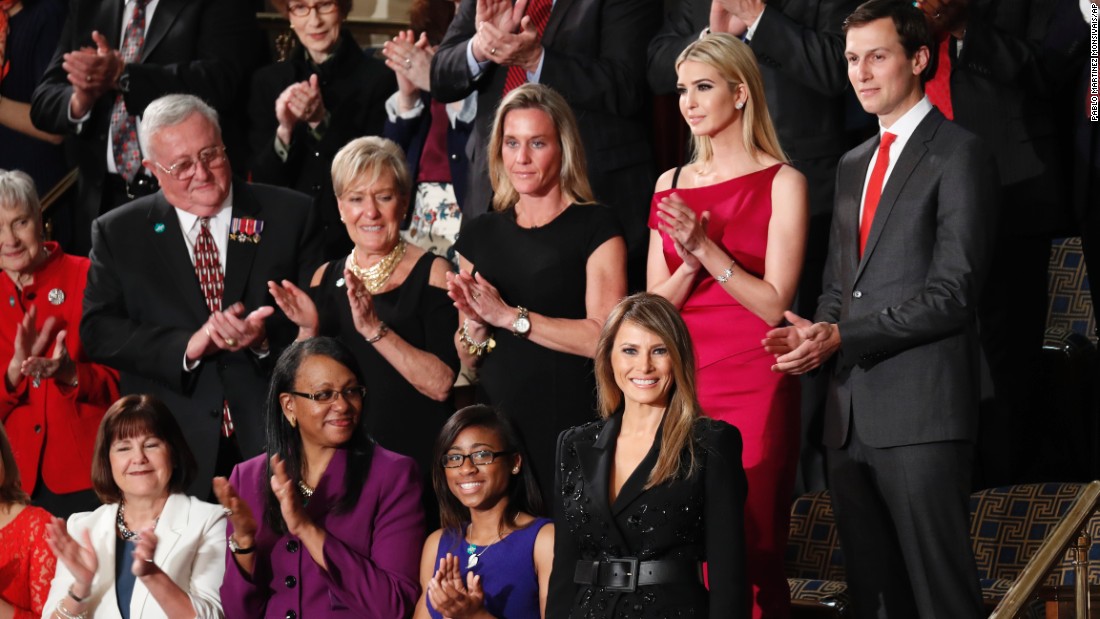 First lady Melania Trump, bottom right, is applauded as she arrives in the chamber.