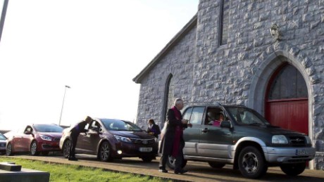 Father Paddy Mooney distributes ashes to parishioners on Ash Wednesday. 