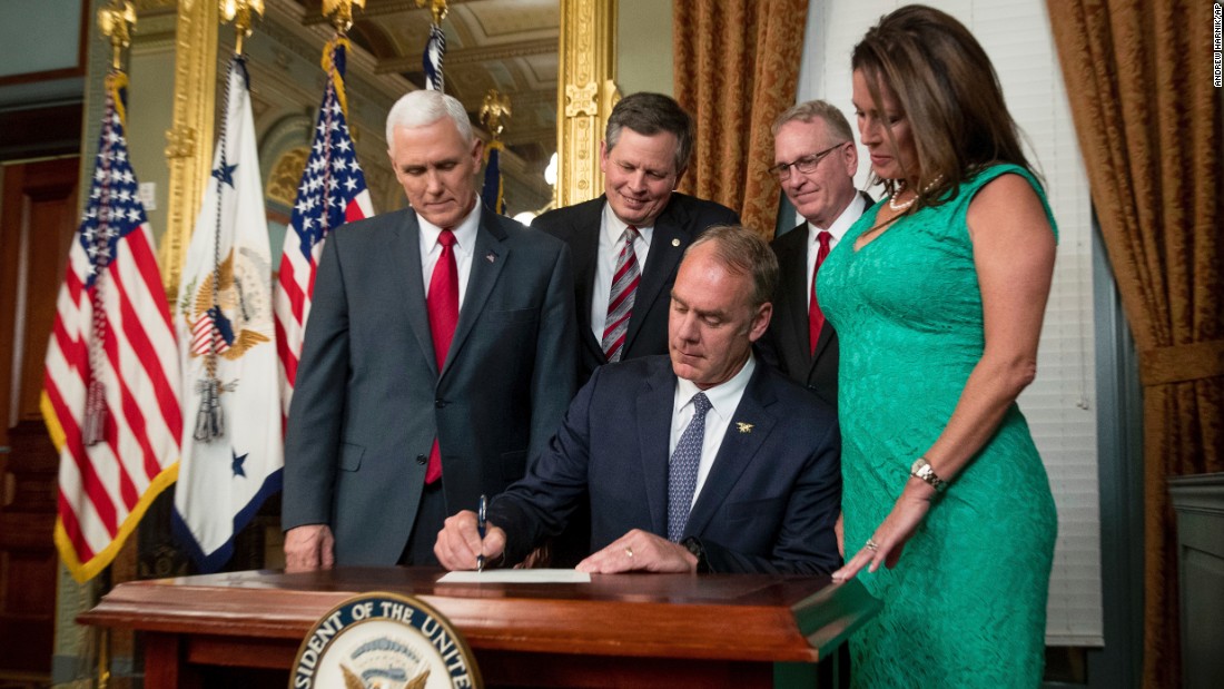 New Interior Secretary Ryan Zinke signs an official document after he was &lt;a href=&quot;http://www.cnn.com/2017/03/01/politics/ryan-zinke-confirmation-vote-interior-secretary/&quot; target=&quot;_blank&quot;&gt;confirmed by the Senate&lt;/a&gt; on Wednesday, March 1. The former congressman from Montana was joined by his wife, Lolita, as well as Vice President Mike Pence, US Sen. Steve Daines and Montana Attorney General Tim Fox.