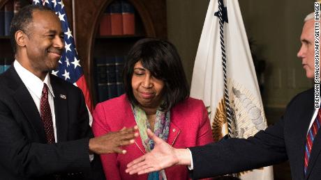 US Secretary of Housing and Urban Development Ben Carson (L) is congratulated by US Vice President Mike Pence (R) as his wife Candy Carson (2L) and granddaughter Tesora Carson watch during his swearing in ceremony in the Eisenhower Executive Office Building on March 2, 2017 in Washington, DC. / AFP PHOTO / Brendan Smialowski        (Photo credit should read BRENDAN SMIALOWSKI/AFP/Getty Images)