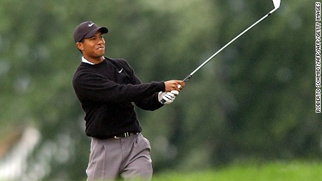 CHASKA, UNITED STATES:  Tiger Woods of the US watches his bunker shot on the 18th hole drop into the cup to finish his suspended second round of 2002 PGA championship 17 August 2002 at Hazeltine National Golf Club in Chaska, Minnesota. Woods finished the round with a 69 for a two-day total of four under par.    AFP PHOTO Roberto SCHMIDT (Photo credit should read ROBERTO SCHMIDT/AFP/Getty Images)