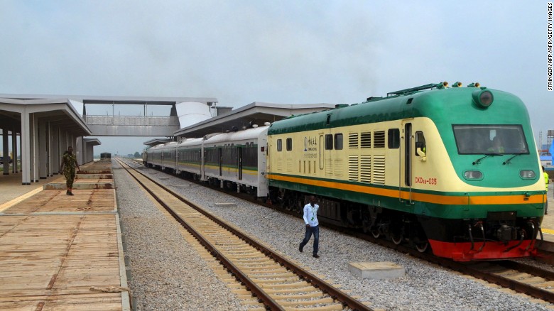 A man walks past a train on the Abuja-Kaduna railway line in Nigeria's capital Abuja, on July 21, 2016.