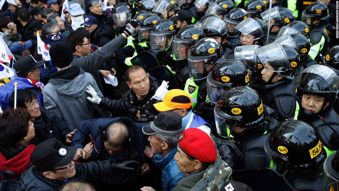 Park supporters are blocked by police during their march toward the Constitutional Court.