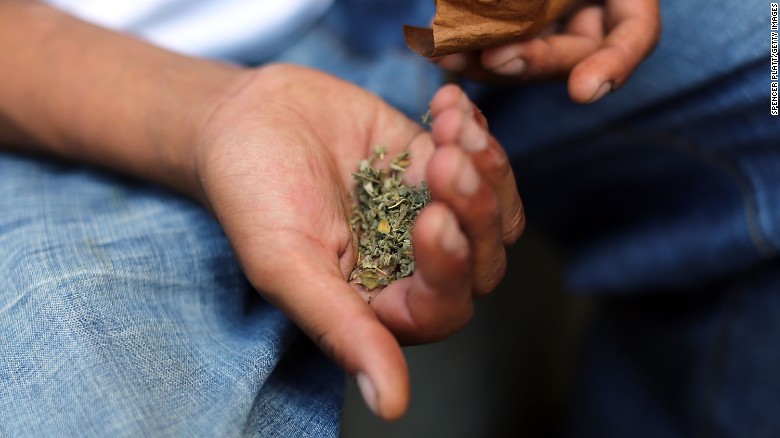 A man prepares to smoke K2 or &quot;Spice&quot;, a synthetic marijuana drug, along a street in East Harlem on August 5, 2015 in New York City. 