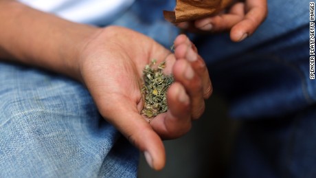 A man prepares to smoke K2 or &quot;Spice&quot;, a synthetic marijuana drug, along a street in East Harlem on August 5, 2015 in New York City. 