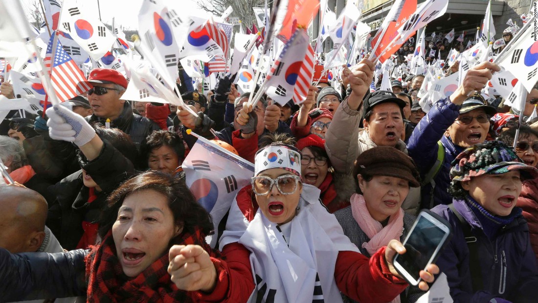 Park supporters shout slogans and wave South Korean flags during a rally to oppose her impeachment.