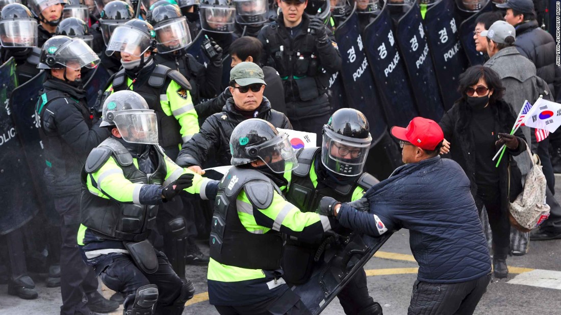 Park supporters clash with police after the country&#39;s Constitutional Court announced it would uphold her impeachment.