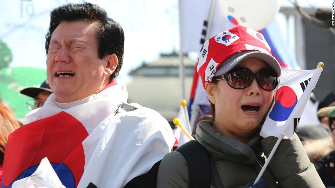 People opposing Park&#39;s impeachment cry during a rally near the Constitutional Court.