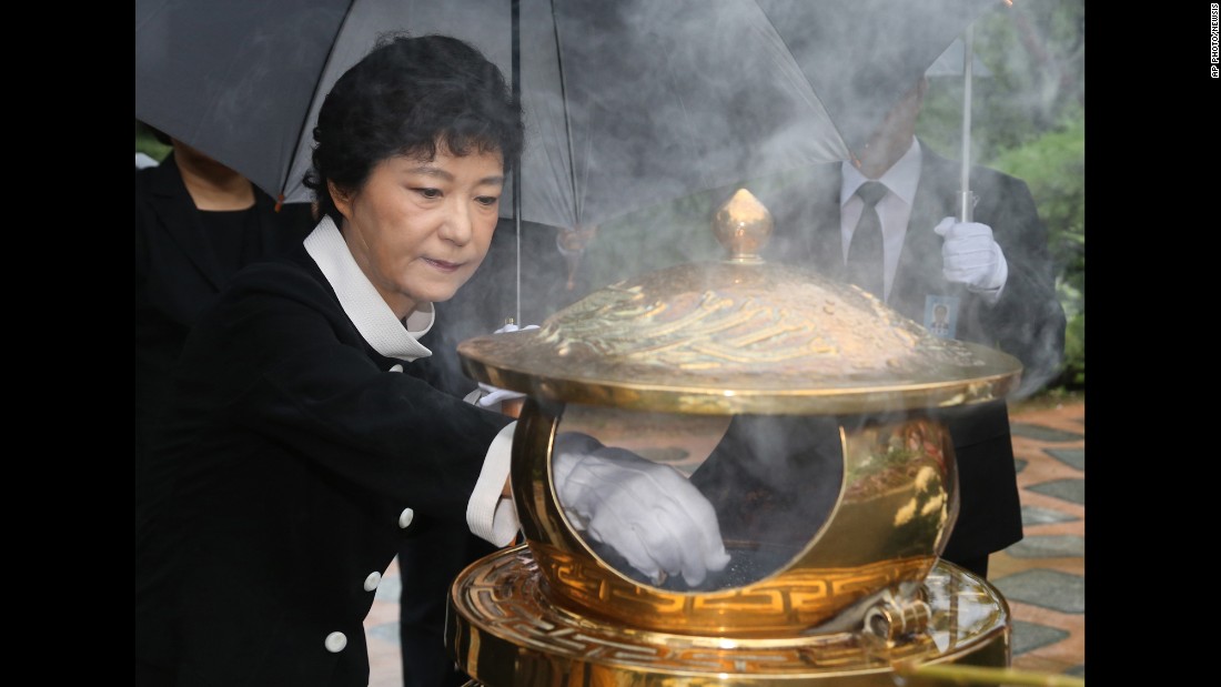 Park burns incense at the tomb of her father in August 2012, soon after she was named the presidential candidate for the ruling Saenuri Party.