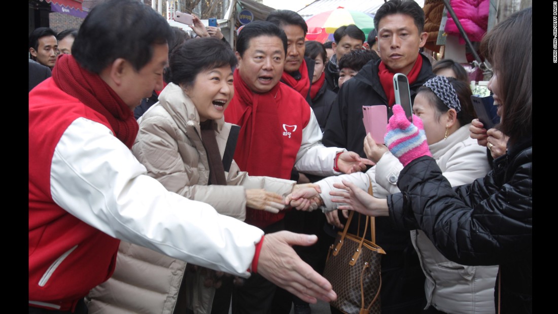 Park greets people in downtown Seoul during the launch of her presidential campaign in November 2012.