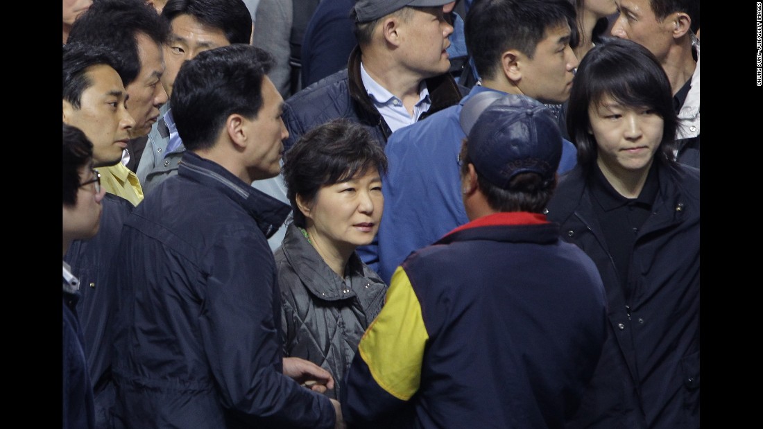 Park talks with families of missing passengers after the Sewol ferry disaster in April 2014. The passenger ferry sank a day earlier, killing 304 people. Most of those aboard were high school students on a field trip to Jeju island, off South Korea&#39;s southern coast.