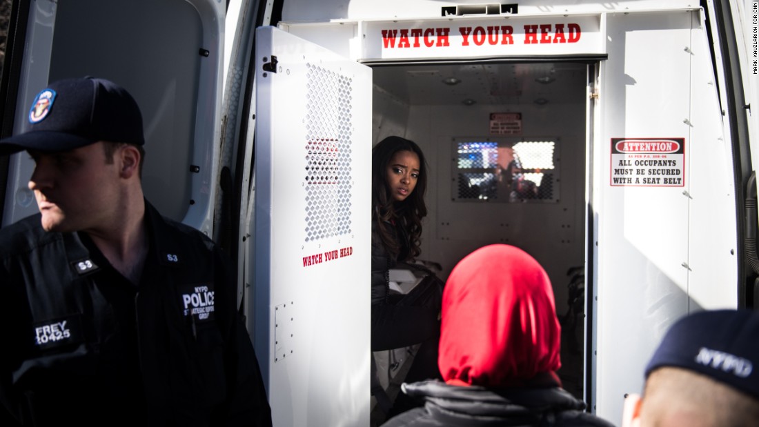 Activist Tamika Mallory, one of the founders of the Women&#39;s March movement, sits in the back of a police van Wednesday, March 8, after being detained for blocking traffic outside the Trump International Hotel and Tower in New York. Thirteen women outside the hotel &lt;a href=&quot;http://www.cnn.com/2017/03/08/politics/womens-march-organizers-detained/&quot; target=&quot;_blank&quot;&gt;were arrested for disorderly conduct&lt;/a&gt; during the &quot;Day Without a Woman&quot; march, a spokesman for the New York Police Department said. &lt;a href=&quot;https://twitter.com/womensmarch/status/839558787753263104&quot; target=&quot;_blank&quot;&gt;The Women&#39;s March tweeted:&lt;/a&gt; &quot;Many of our national organizers have been arrested in an act of civil disobedience. We will not be silent.&quot;