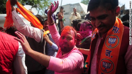 Voters celebrate outside the in Lucknow on March 11, 2017.