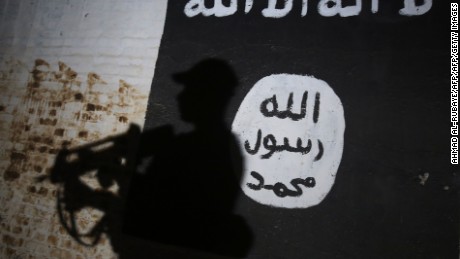 TOPSHOT - A member of the Iraqi forces walks past a mural bearing the logo of the Islamic State (IS) group in a tunnel that was reportedly used as a training centre by the jihadists, on March 1, 2017, in the village of Albu Sayf, on the southern outskirts of Mosul.
Iraqi forces launched a major push on February 19 to recapture the west of Mosul from the Islamic State jihadist group, retaking the airport and then advancing north. / AFP PHOTO / AHMAD AL-RUBAYE        (Photo credit should read AHMAD AL-RUBAYE/AFP/Getty Images)