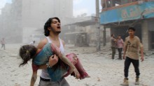 A man carries a young girl who was injured in a reported barrel-bomb attack by government forces on June 3, 2014 in Kallaseh district in the northern city of Aleppo. Some 2,000 civilians, including more than 500 children, have been killed in regime air strikes on rebel-held areas of Aleppo since January, many of them in barrel bomb attacks. AFP PHOTO / BARAA AL-HALABI        (Photo credit should read BARAA AL-HALABI/AFP/Getty Images)