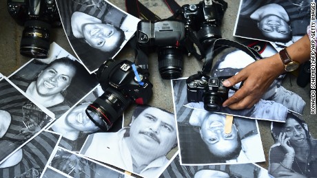 Protesters show photos of journalists killed over the years in Veracruz, Mexico. 