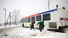 Blaine Webb helps a SEPTA employee shovel out a bus from the snow March 14, 2017 in Spring City, Pennsylvania.  