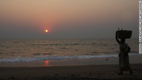 A woman walks on a beach in Goa, an Indian state popular with tourists from around the world.