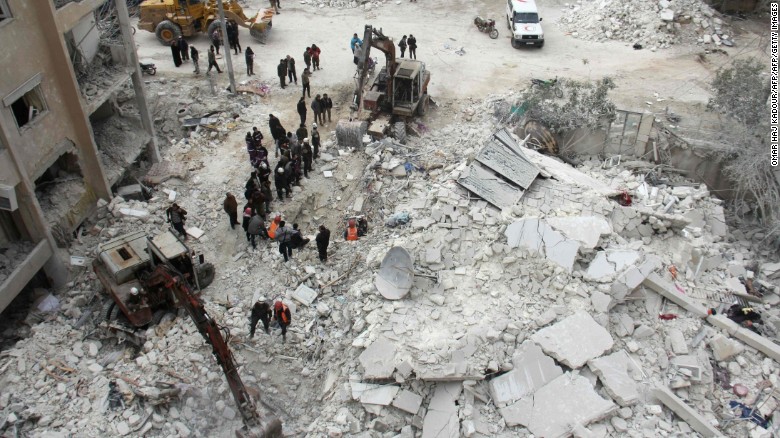 Rescuers search for victims after an air strike in the Syrian city of Idlib on March 15, 2017. Russia has propped up President Bashar al-Assad&#39;s with air power.