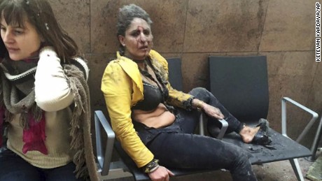 In this March 22, 2016 file photo provided by photographer Ketevan Kardava, Nidhi Chaphekar, a Jet Airways flight attendant from Mumbai, right, and another unidentified woman are shown after being wounded in Brussels Airport in Brussels, Belgium, after explosions rocked the airport. Chaphekar said she has recovered 70 percent of her previous fitness level and would like to resume her passion, flying. (Ketevan Kardava via AP, File)