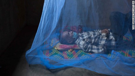Sam Mowum, 71, takes a nap inside his home in Proy village in Momot district, Cambodia. To avoid infecting his family, Sam Moeum left the family home to complete his treatment and now lives alone. 