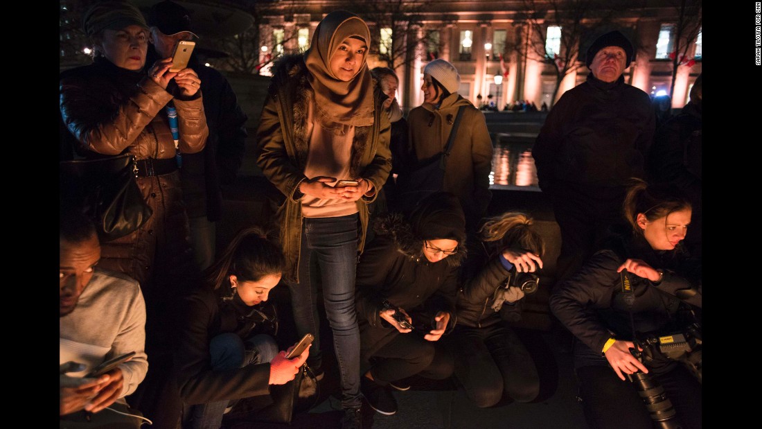 Friends Aklima Ahmed, 19, (bottom left), Lipa Nessa, 18, (center, standing), and Aklima Ahmed, 19, participate in the vigil. Nessa told CNN that &quot;as a Muslim, I felt I had to come here to show that nothing can divide us, that we are united together, to make London stronger.&quot;