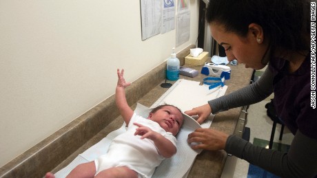 Mariela Duran, a pediatric medical assistant at Inner City Health Center in Denver, Colorado measures three week old Elias Martinez during a visit at Inner City Health Center in Denver, Colorado on March 15, 2017. Inner City Health Center was founded in 1983 and offers medical, dental, and mental and behavioral health services to the uninsured and underserved populace of Denver County and surrounding Colorado communities. Services are offered to patients based on a sliding scale, and 65% of the patient population is below  200% of the federal poverty level. ICHC serves more than 22,000 patients annually.  / AFP PHOTO / Jason Connolly        (Photo credit should read JASON CONNOLLY/AFP/Getty Images)