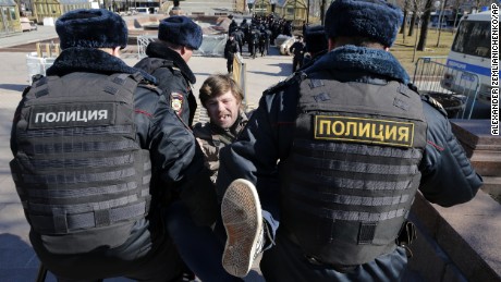 Police detain a protester in central Moscow on Sunday.