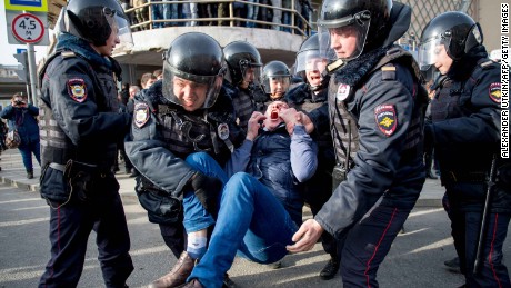 Riot police officers detain a protester during an unauthorised anti-corruption rally in central Moscow on March 26.