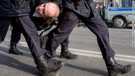 Police officers detain a man during an unauthorized anti-corruption rally in central Moscow on March 26.