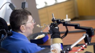 Paralyzed man uses experimental device to regain hand movements  