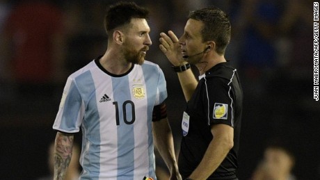 Lionel Messi speaks with the assistant referee during Argentina&#39;s win over Chile.