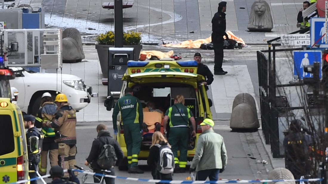 An injured person is put in an ambulance.