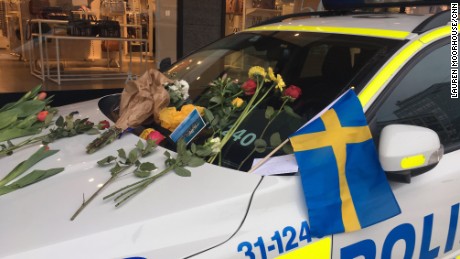 Cards and flowers have been left on police car windshields in the city center, thanking officers for their work.