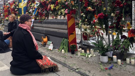 A mourner prays at a memorial near the site of the Stockholm attack.