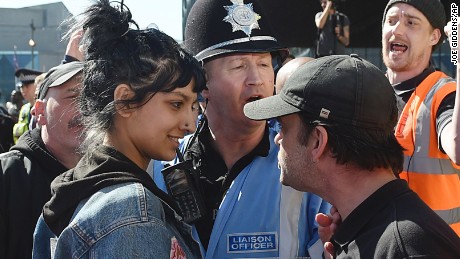 An English Defence League member, right, and a woman identified Saffiyah Khan, are pictured during an EFL rally in Birmingham, England, on Saturday.