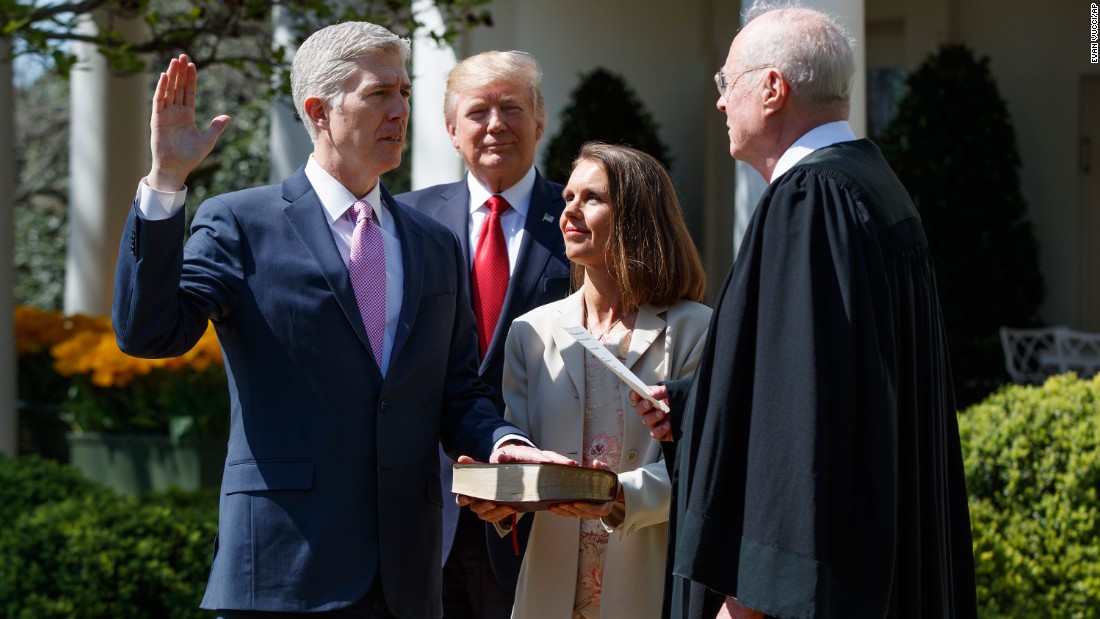 President Donald Trump watches as Supreme Court Justice Anthony Kennedy, right, administers the judicial oath to Neil Gorsuch during &lt;a href=&quot;http://www.cnn.com/2017/04/10/politics/neil-gorsuch-trump/&quot; target=&quot;_blank&quot;&gt;a White House ceremony&lt;/a&gt; on Monday, April 10. Gorsuch was chosen by Trump to replace Supreme Court Justice Antonin Scalia, who died in 2016. Holding the Bible is Gorsuch&#39;s wife, Marie Louise.