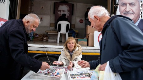 A supporter from the ruling AKP distributes candies saying &quot;Evet&quot; or &quot;Yes&quot; along with yes campaign papers in the middle of Istanbul on Sunday, April 9, 2017. 