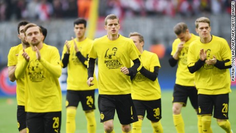 Showing support. Dortmund´s players wear T-shirts with &#39;Mucha Fuerza&#39; (A lot of strength) and a picture of injured teammate Marc Bartra on the front.