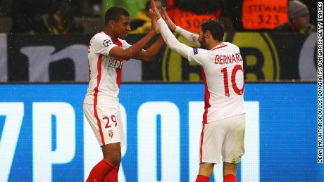 Striker Kylian Mbappe celebrates with Bernardo Silva after scoring the first of his two goals against Dortmund.