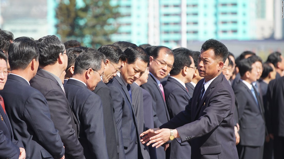 North Koreans gather to witness the opening of the Ryomyong Street housing development.