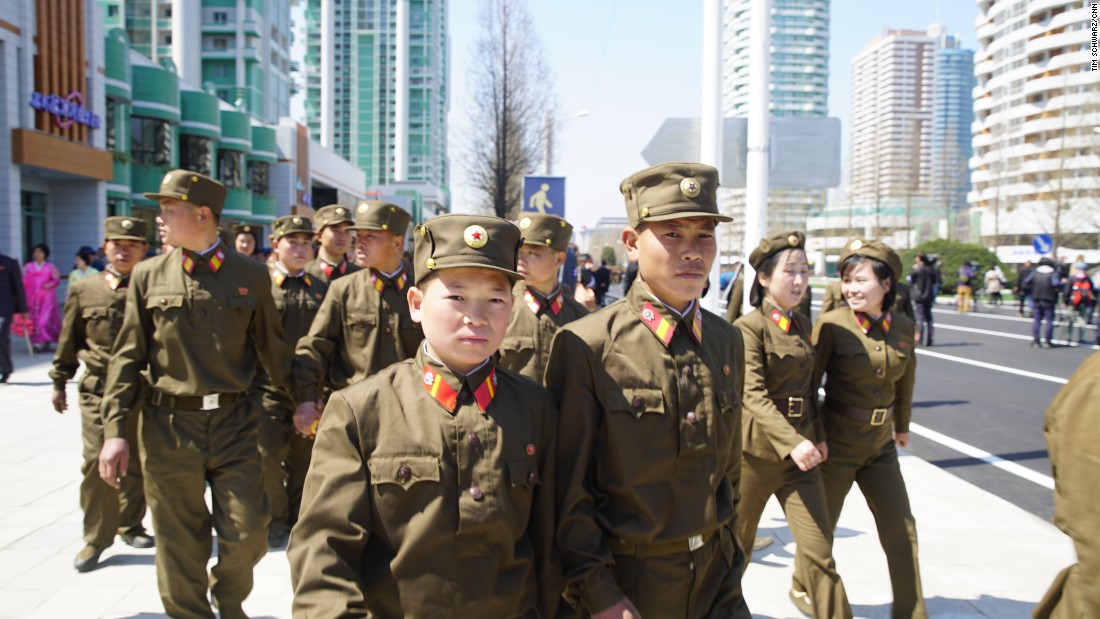 Soldiers leave the opening ceremony of the Ryomyong Street development.