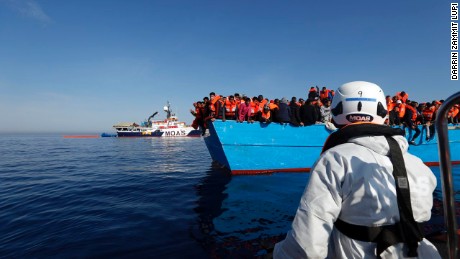 Ships from the humanitarian organization Migrant Offshore Aid Station approach a boat with migrants in the Mediterranean Sea on April 15. 
