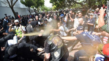A man gets sprayed with a chemical irritant as multiple fights break out between Trump supporters and anti-Trump protesters in Berkeley, California on April 15, 2017. 