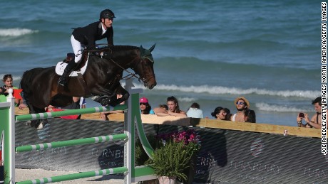 MIAMI BEACH, FL - APRIL 03:  Richie Moloney jumps his horse over a hurdle during the Longines Global Champions Tour stop in Miami Beach on April 3, 2015 in Miami Beach, Florida. The tour, which visits locations around the world, brings together many of the top ranked show jumpers in the world to compete in prestigious locations for prize money.(Photo by Joe Raedle/Getty Images)