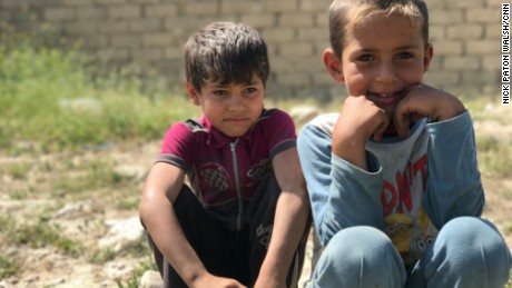 Children who fled the fighting in western Mosul waiting at a collection point for displaced families.  