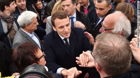 French presidential election candidate for the En Marche ! movement Emmanuel Macron shakes hands with supporters after voting at a polling station in Le Touquet, northern France, on April 23, 2017, during the first round of the Presidential election. / AFP PHOTO / Philippe HUGUEN        (Photo credit should read PHILIPPE HUGUEN/AFP/Getty Images)