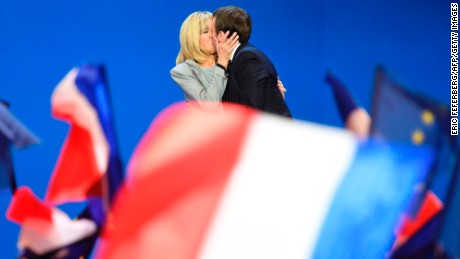 Macron kisses his wife after winning the first round in April.