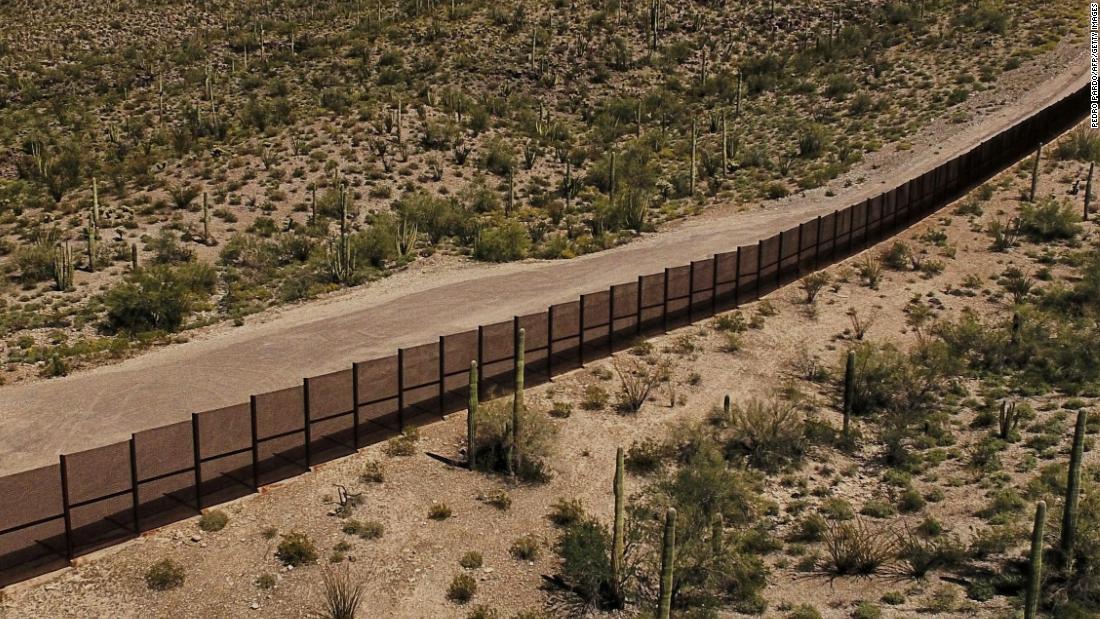 A metal fence stands between Sonoyta, Mexico, and the Arizona desert.